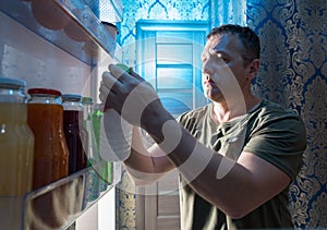 Man selecting something to drink from a fridge