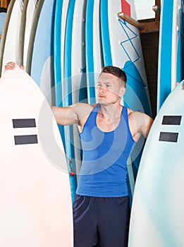 man selecting surfboard for rent