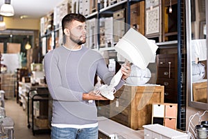 man selecting table lamp