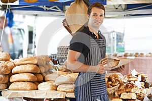 Man Selling Bread At Outdooor Market photo