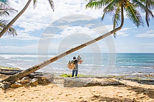 A man selling coconuts and pineapples on the beach, Hikkaduwa, Sri Lank