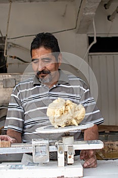 Man selling dough in nixtamal mill