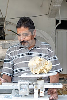 Man selling dough in nixtamal mill photo