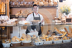 Man selling fresh pastry and baguettes