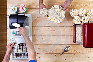 Man selling freshly made bowls of popcorn