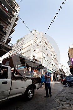 Man selling fruits out of his car in the street in Athens, Greece