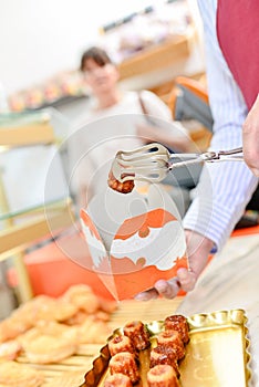 man selling pastries in local store