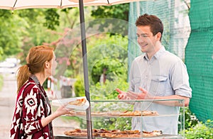 Man selling pizza by slice