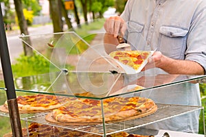 Man selling pizza by slice