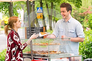 Man selling pizza by slice