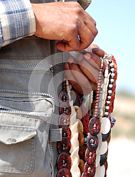 Man selling stone necklaces