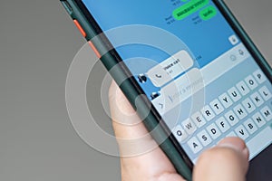 Man sending text message and sms with smartphone Communication concept. Finger typing with cellphone keyboard