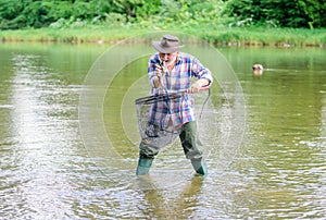 Man senior bearded fisherman. Pensioner leisure. Fish farming pisciculture raising fish commercially. Fisherman fishing