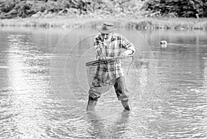Man senior bearded fisherman. Pensioner leisure. Fish farming pisciculture raising fish commercially. Fisherman fishing photo