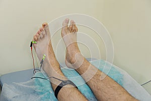 Man with sensors on his leg in the clinic.