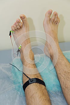 Man with sensors on his leg in the clinic.