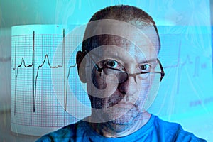 Man with a serious expression looking at the camera superimposed on an electrocardiogram