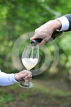 Man serves champagne to his woman