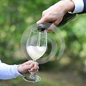 Man serves champagne to his woman