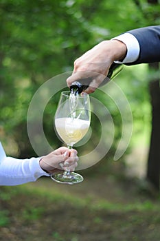 Man serves champagne to his woman