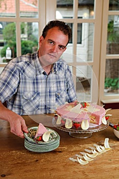 Man serving cake in kitchen