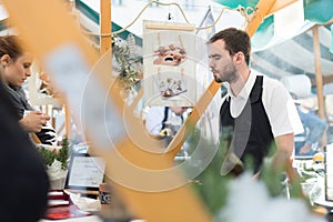 Man serving street food on international cuisine event in Ljubljana, Slovenia.