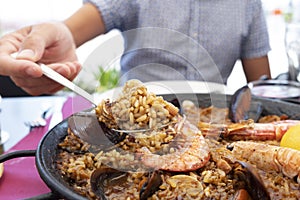 Man serving a typical spanish seafood paella photo