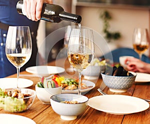 Man serving wine during dinner