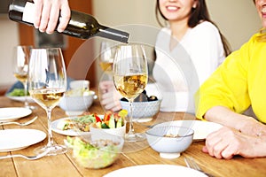 Man serving wine during dinner