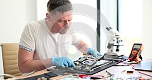 A man sets components in a PC, close-up