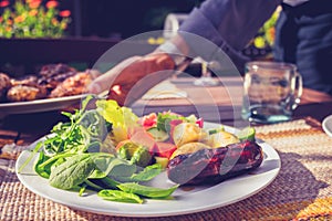 Man setting table at outdoors barbecue