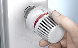 Man setting thermostat temperature to the higher position