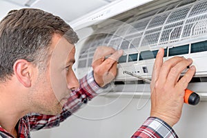 Man setting up an air conditioning unit