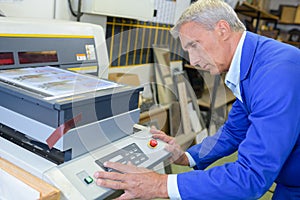 Man setting up photocopying machine