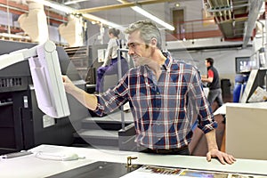 Man setting up a printing machine