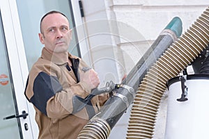 Man setting up ventilation system outdoors