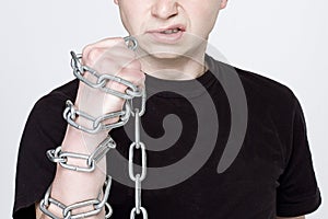 Man and shackles. The concept of freedom, hatred, revenge