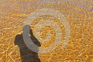 Man shadow, sea Water and Sand Structure Golden fine sand