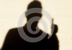 Man in shadow, thumb up