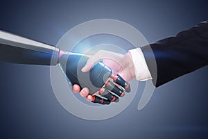 Man shaking robot hand, dark gray wall