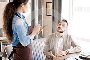 Man sharing his taste preference with waitress photo