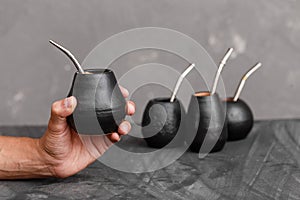 A man sharing Yerba Mate tea in gourd with sipped metal straw