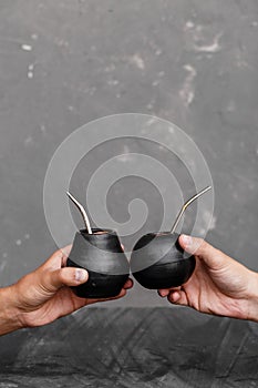 A man sharing Yerba Mate tea in gourd with sipped metal straw