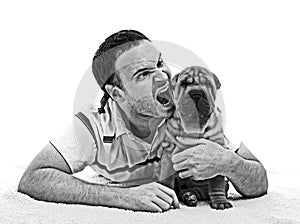 Man with sharpei puppy black and white