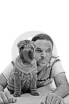 Man with sharpei puppy black and white