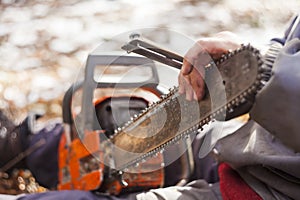 man sharpening motor chainsaw blade