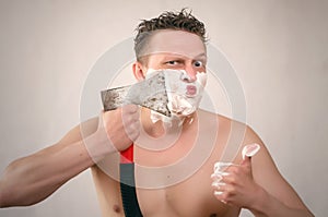 Man shaving by axe.