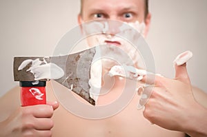 Man shaving by axe.