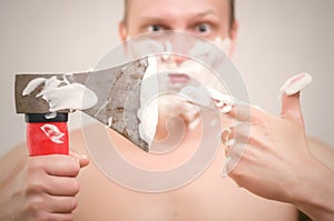 Man shaving by axe.