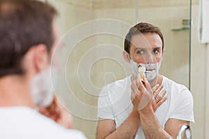 Man shaving in the bathroom